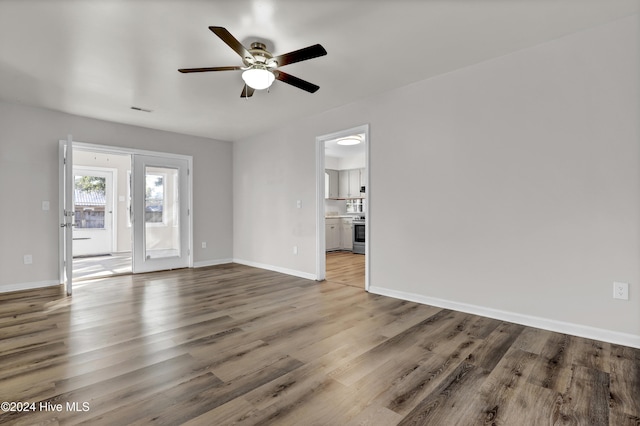 unfurnished living room featuring hardwood / wood-style floors and ceiling fan