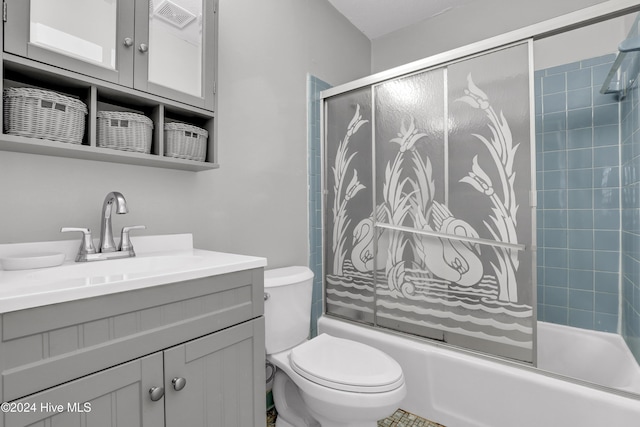 full bathroom featuring combined bath / shower with glass door, toilet, and vanity