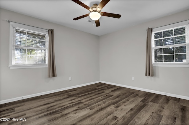 spare room with dark hardwood / wood-style flooring and ceiling fan