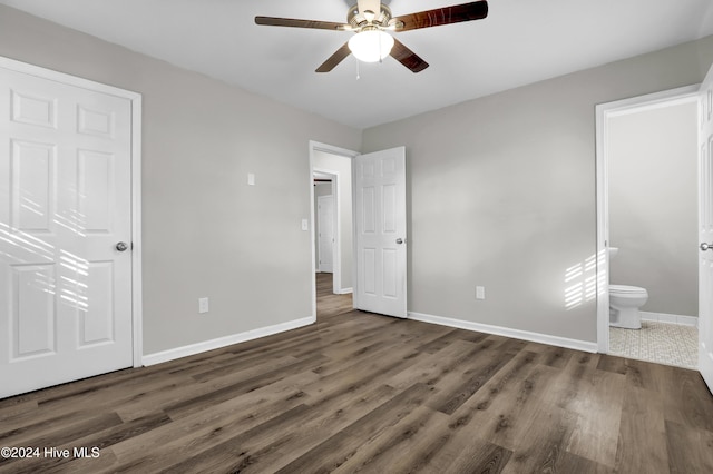 unfurnished bedroom with dark hardwood / wood-style floors, ceiling fan, and ensuite bathroom