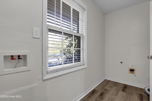 laundry area with electric dryer hookup, hookup for a washing machine, and hardwood / wood-style floors