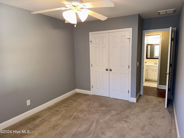 unfurnished bedroom featuring ceiling fan, a closet, and carpet floors