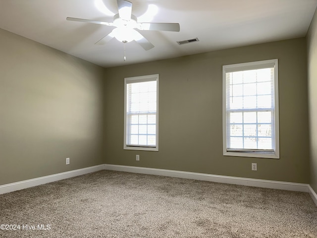 carpeted empty room with plenty of natural light and ceiling fan