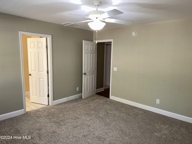 unfurnished bedroom with ceiling fan and light colored carpet