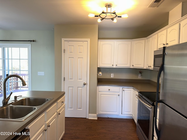 kitchen featuring dark hardwood / wood-style floors, white cabinetry, sink, and appliances with stainless steel finishes