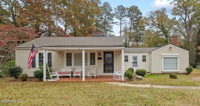 ranch-style house with a porch and a front lawn