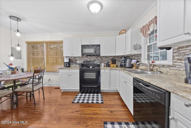 kitchen featuring sink, hardwood / wood-style floors, decorative light fixtures, white cabinets, and black appliances