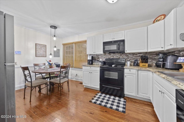 kitchen with pendant lighting, light hardwood / wood-style flooring, white cabinetry, and black appliances