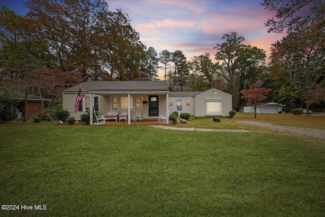 ranch-style house with a lawn and a porch