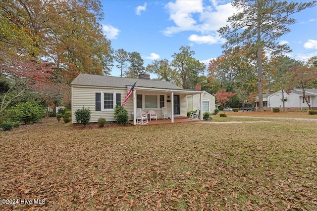 view of front of house with a front yard and a porch