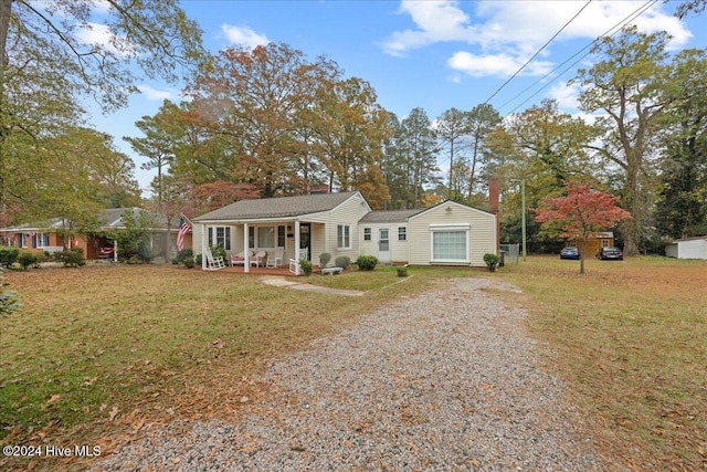 ranch-style house with covered porch and a front lawn