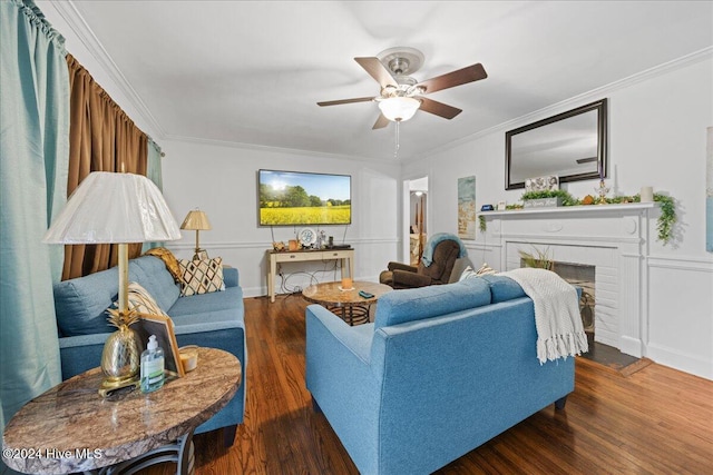 living room featuring dark hardwood / wood-style floors, a brick fireplace, and crown molding