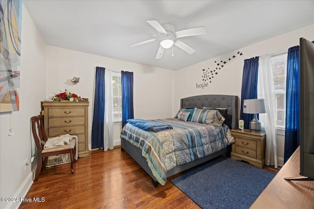 bedroom featuring ceiling fan and dark hardwood / wood-style flooring