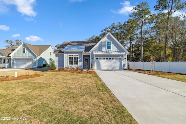 view of front of property with a standing seam roof, fence, board and batten siding, and a front yard