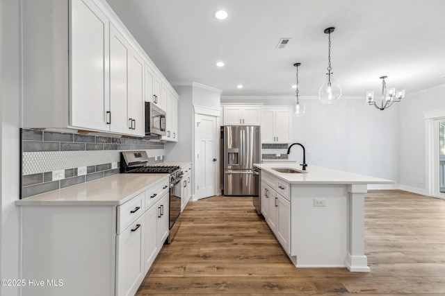 kitchen featuring light countertops, appliances with stainless steel finishes, and white cabinetry