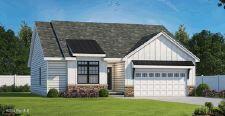 view of front of property featuring a garage, driveway, a front lawn, and fence