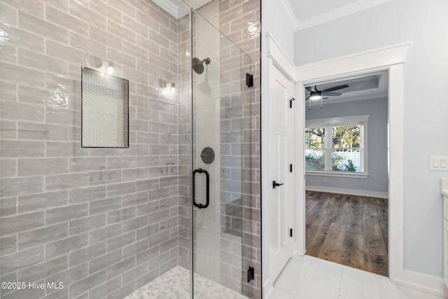 bathroom with ornamental molding, tile patterned flooring, a shower stall, and baseboards