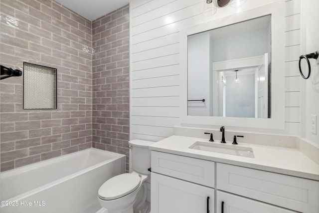 bathroom with toilet, tub / shower combination, and vanity