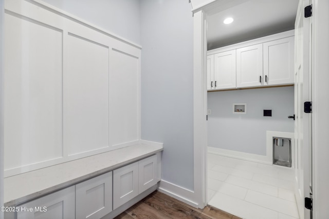 mudroom with recessed lighting, dark wood-style flooring, and baseboards