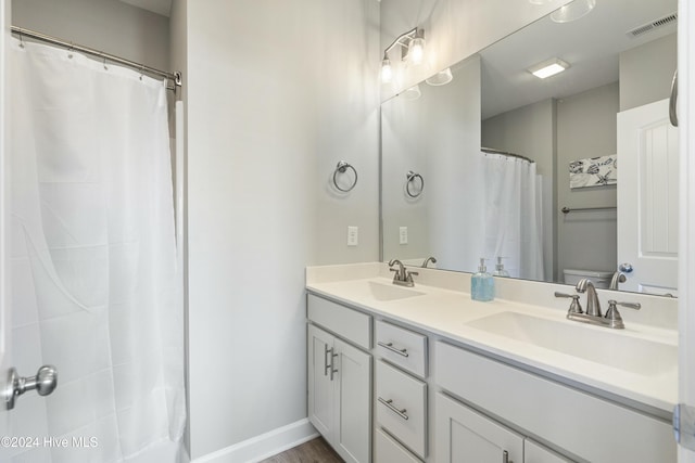 bathroom featuring a shower with curtain, vanity, and hardwood / wood-style flooring