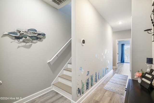 stairway featuring hardwood / wood-style flooring