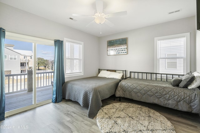 bedroom featuring access to exterior, wood-type flooring, and ceiling fan