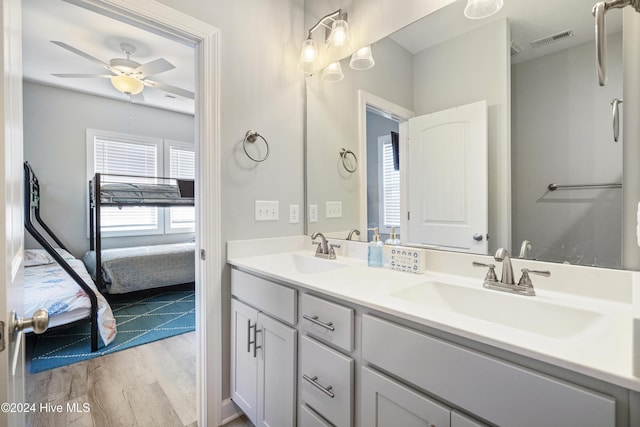 bathroom featuring ceiling fan, hardwood / wood-style floors, and vanity