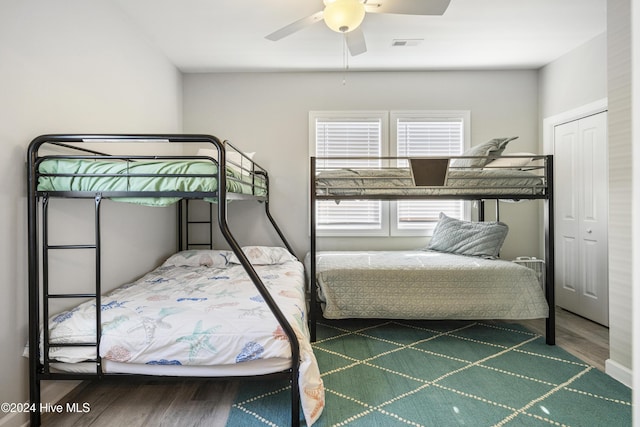 unfurnished bedroom featuring a closet, hardwood / wood-style flooring, and ceiling fan