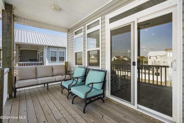 wooden deck with outdoor lounge area and a porch