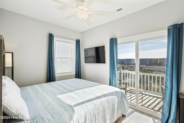 bedroom featuring access to outside, multiple windows, and ceiling fan