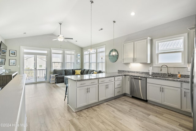 kitchen with kitchen peninsula, stainless steel dishwasher, vaulted ceiling, sink, and light hardwood / wood-style floors