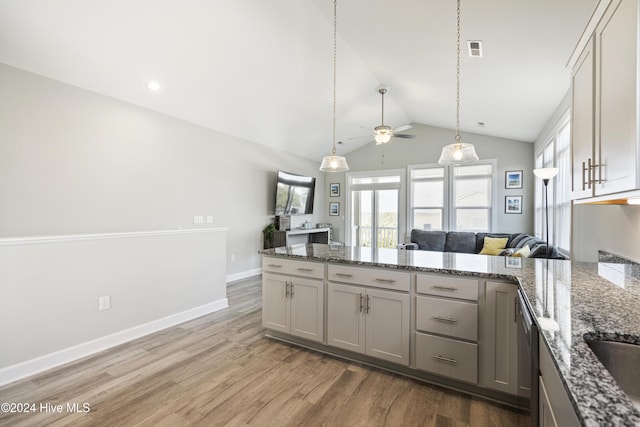 kitchen with gray cabinets, ceiling fan, wood-type flooring, and lofted ceiling