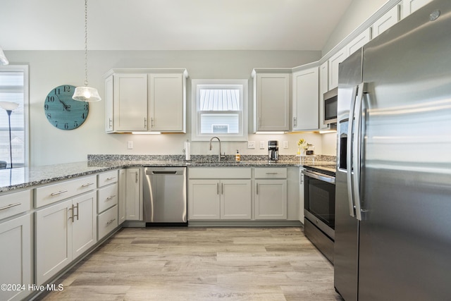 kitchen featuring light hardwood / wood-style floors, white cabinetry, sink, and appliances with stainless steel finishes