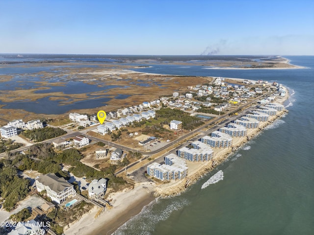 drone / aerial view with a beach view and a water view