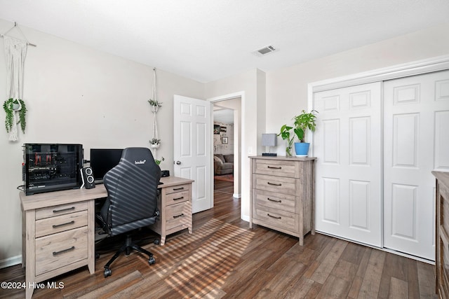 office area with dark hardwood / wood-style flooring and a textured ceiling