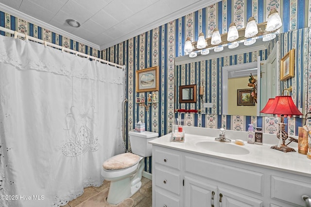 bathroom with toilet, tile patterned flooring, ornamental molding, vanity, and curtained shower