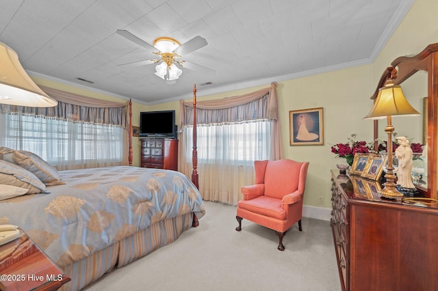 carpeted bedroom featuring ceiling fan and crown molding