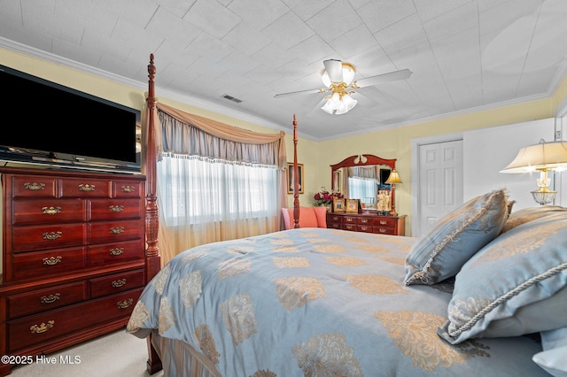 carpeted bedroom featuring ceiling fan and ornamental molding