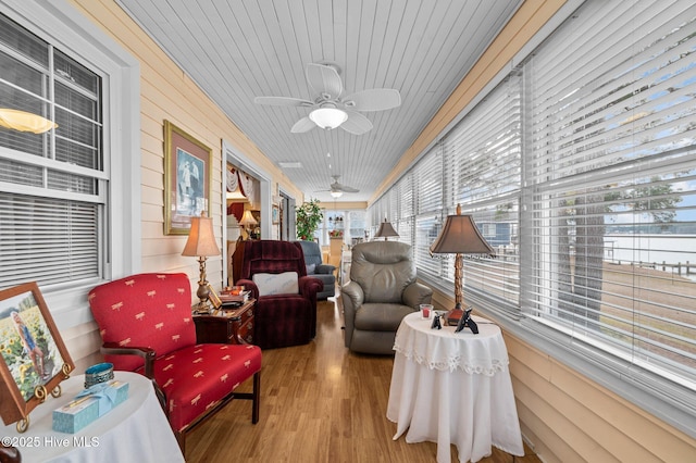 sunroom / solarium featuring ceiling fan and wooden ceiling