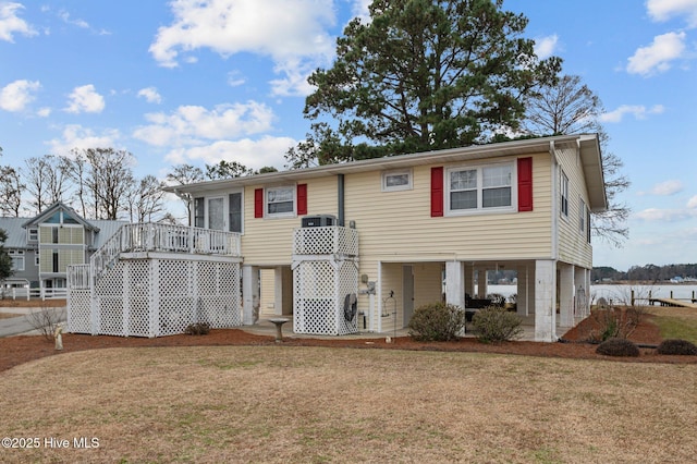 view of front facade featuring a wooden deck and a front yard