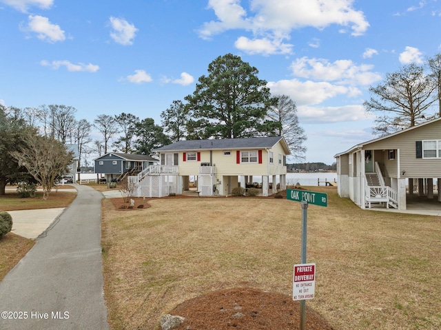 view of front of property with a front yard and a water view