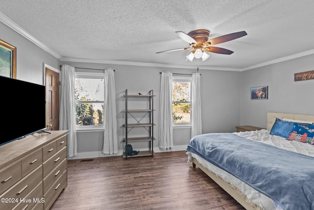 bedroom featuring ceiling fan, dark hardwood / wood-style flooring, ornamental molding, and multiple windows