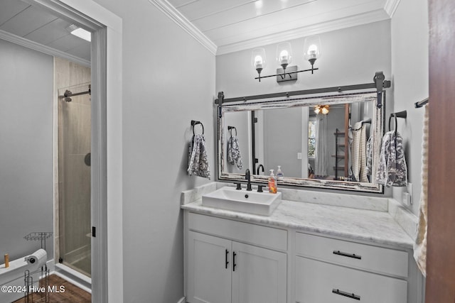 bathroom with crown molding, vanity, hardwood / wood-style flooring, and walk in shower