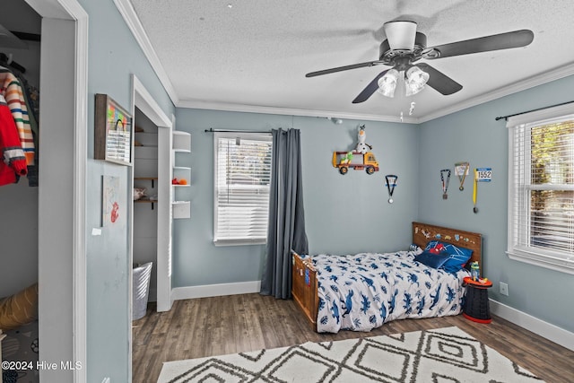 bedroom with ceiling fan, crown molding, and multiple windows