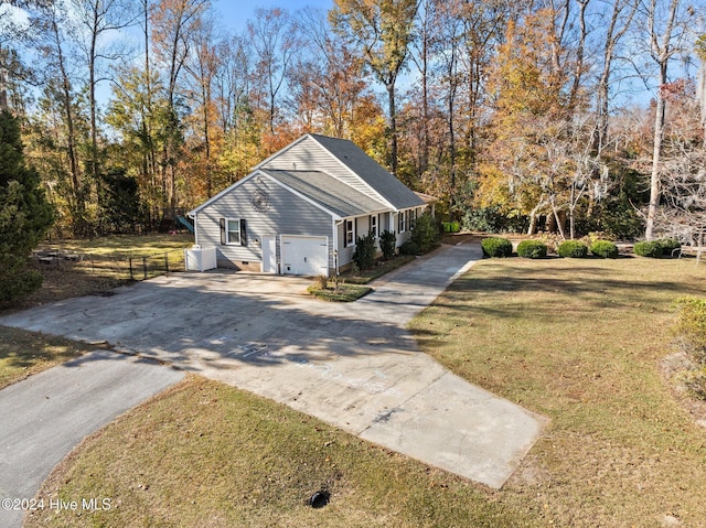 view of side of home featuring a garage and a yard