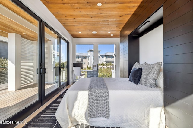 bedroom featuring wooden walls, wood ceiling, and lofted ceiling