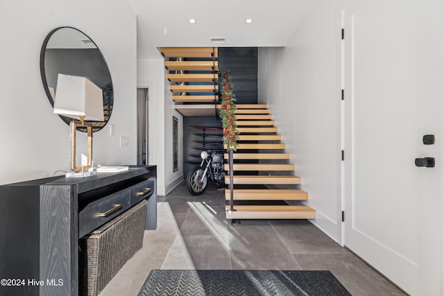 stairway featuring concrete floors