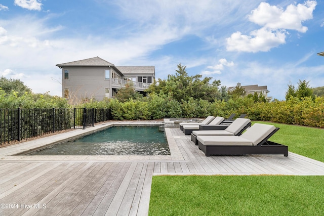 view of pool with a yard and a wooden deck