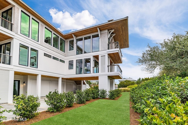 rear view of property featuring a lawn