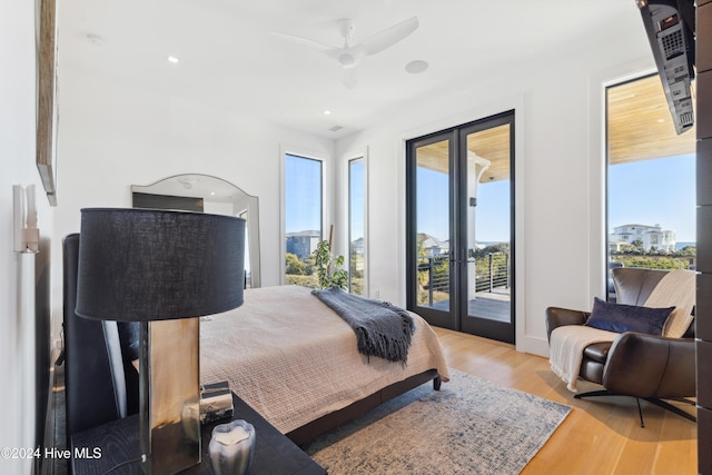 bedroom with access to outside, ceiling fan, french doors, and light wood-type flooring